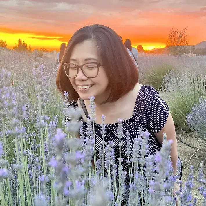 Marian Antona smiling among lavender flowers at sunset